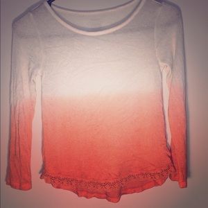 A white and orange long sleeve shirt 7/8 size